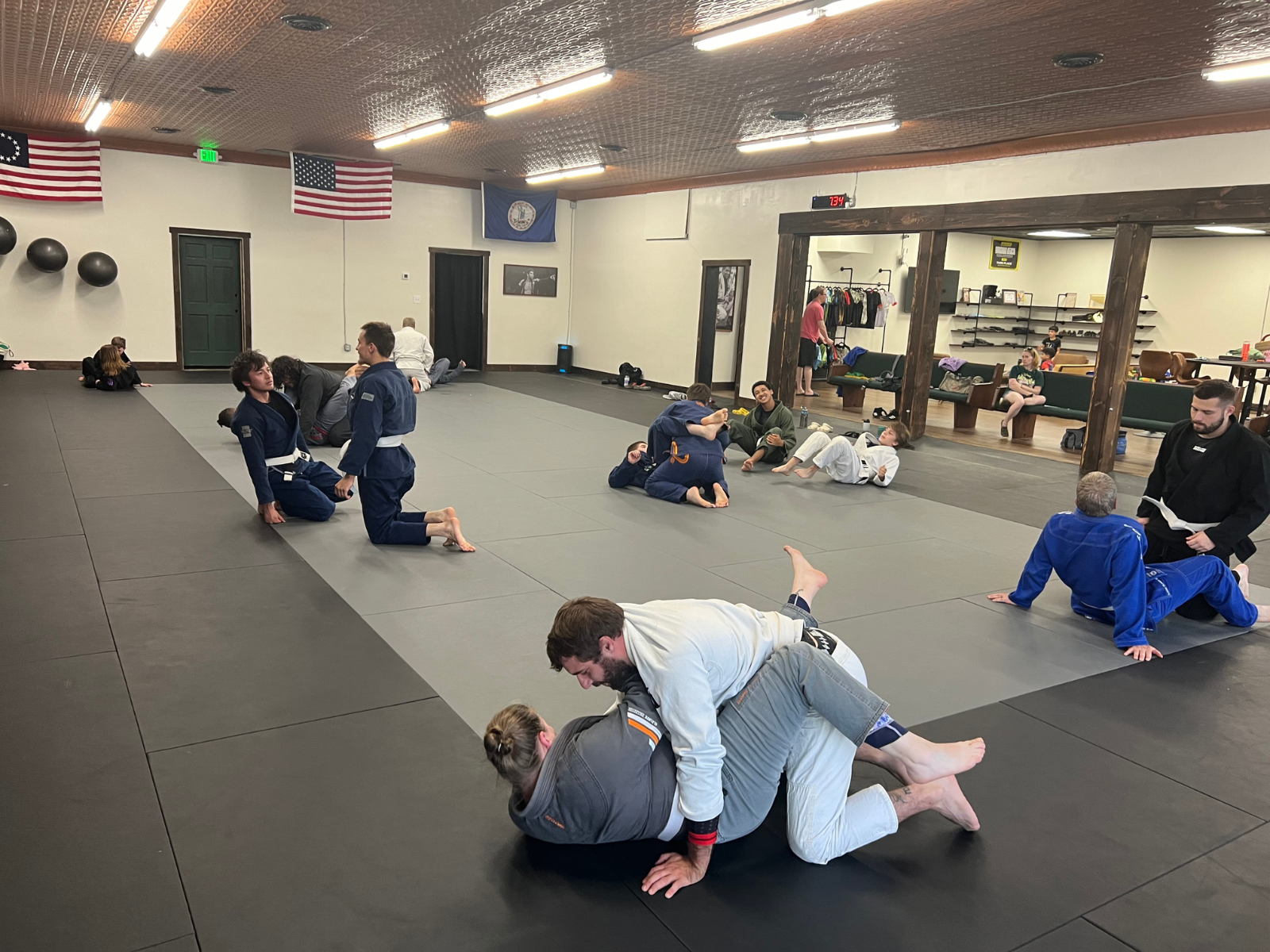 Adults training Gi BJJ on the mats